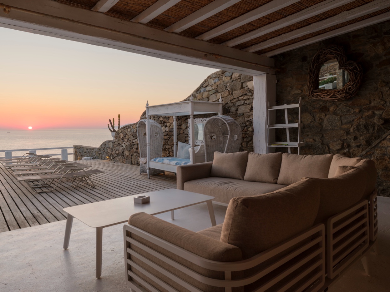Pool and Aegean framed from terrace at dusk