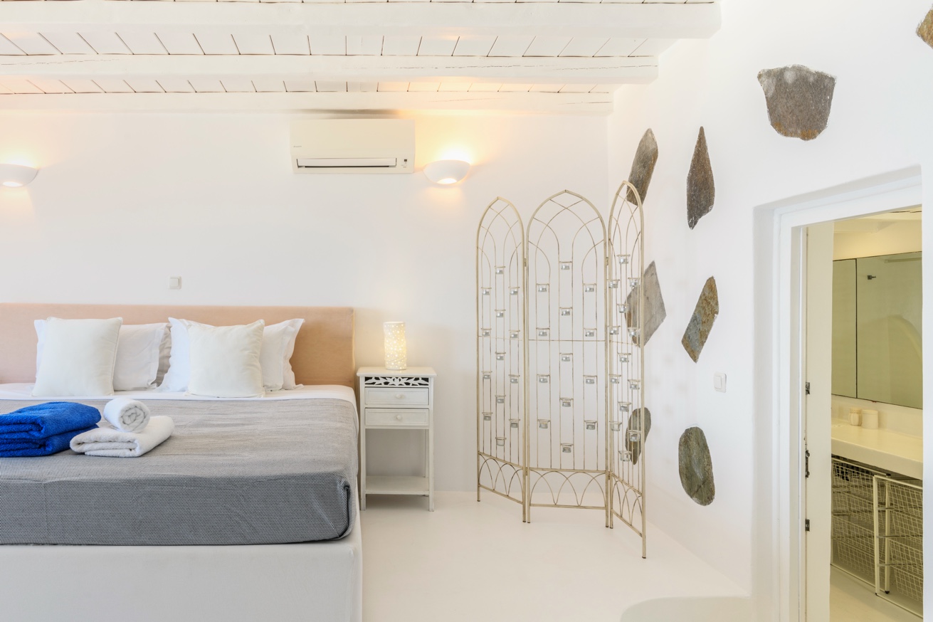Master bedroom with carved antique bed and sea view
